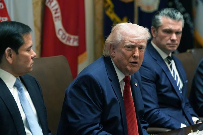 US President Donald Trump speaks during a Cabinet meeting at the White House, in Washington, DC. With him are Secretary of State Marco Rubio (left) and Secretary of Defence Pete Hegseth.