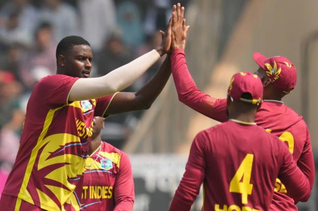 West Indies’ Jason Holder (second left) and teammates celebrate the dismissal of Nepal’s Aarif Sheikh during the ICC T20 World Cup cricket match in Mumbai, India on February 15.