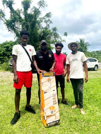 Member of Parliament for South‑East St Mary, Christopher Brown (second from left), with beneficiaries after presenting a weed whacker under the A‑Start Initiative on Wednesday.