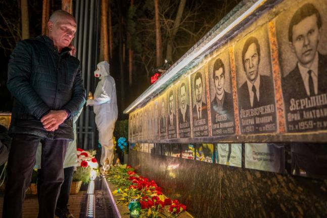 A man looks at a memorial dedicated to firefighters and workers who died after the 1986 Chornobyl (Chernobyl) nuclear disaster, ahead of its 40th anniversary in Slavutych, Ukraine. Chornobyl is the Ukrainian name for the city.