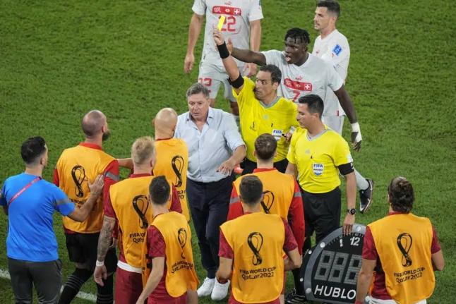 Referee Fernando Rapallini displays a yellow card to a Serbian player from the bench during the World Cup Group G football match against Switzerland, at the Stadium 974 in Doha, Qatar on Friday. Switzerland won 3-2.