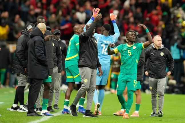 FILE – Senegal’s Idrissa Gueye (right) calls players to walk off the pitch during the Africa Cup of Nations final between Senegal and Morocco, in Rabat, Morocco, Sunday, January 18, 2026. 