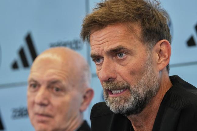 Newly appointed head coach of the German national football team Juergen Klopp (right) at a news conference at the headquarters of the German Football Association DFB in Frankfurt, Germany yesterday.