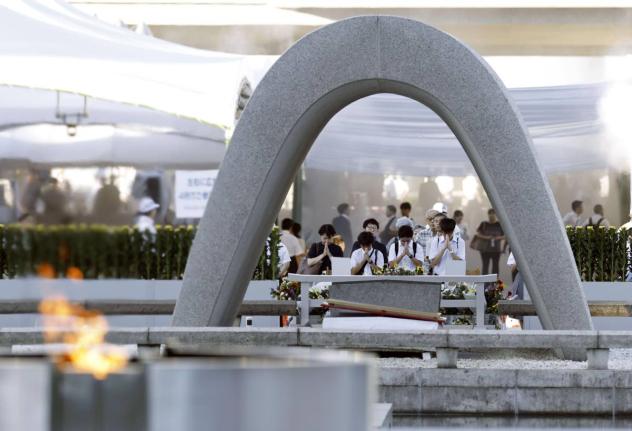 Visitors pray in front of the cenotaph dedicated to the victims of the atomic bombing ahead of a ceremony to mark the anniversary of the bombing at the Hiroshima Peace Memorial Park in Hiroshima, western Japan, Thursday.