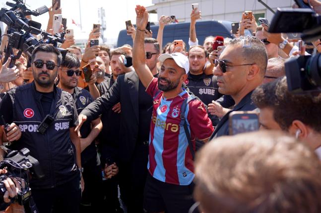 Egypt’s Mohamed Salah wearing his new Trabzonspor team jersey gestures to supporters as he arrives at the airport in Istanbul, Turkey, Wednesday, August 5, 2026. 