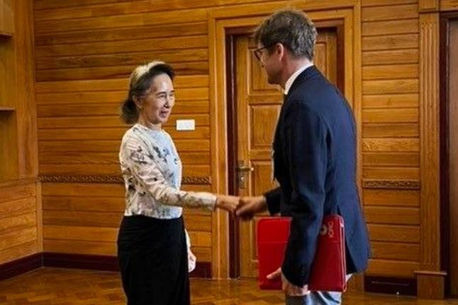 In this photo released by Myanmar President Office, Myanmar’s ousted leader Aung San Suu Kyi (left) shakes hands with Arnaud de Baecque, resident representative of the International Committee of the Red Cross, during their meeting in Naypyitaw, Myanmar. 