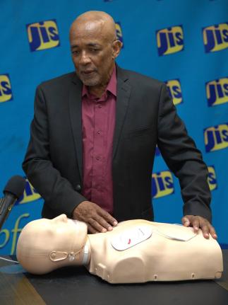 Dr Lambert Innis, Senior Instructor at the Heart Foundation of Jamaica, demonstrates the proper use of an Automated External Defibrillator (AED) 