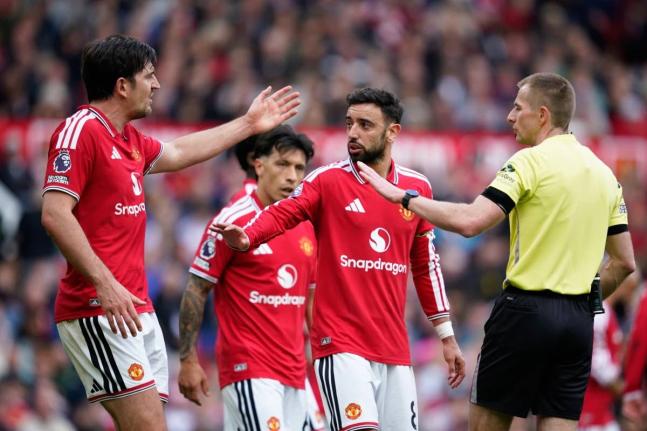 Manchester United’s Harry Maguire (left) argues with referee Michael Salisbury during the English Premier League  match between Manchester United and Nottingham Forest in Manchester, England yesterday. At centre is Bruno Fernandes. 