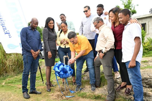 Minister of Water, Environment and Climate Change, Matthew Samuda (centre), turns on a pipe to officially commission the Spring Garden Water Supply System in St James on Wednesday. Looking on are Mayor of Montego Bay and Chairman of the St James Municipal 