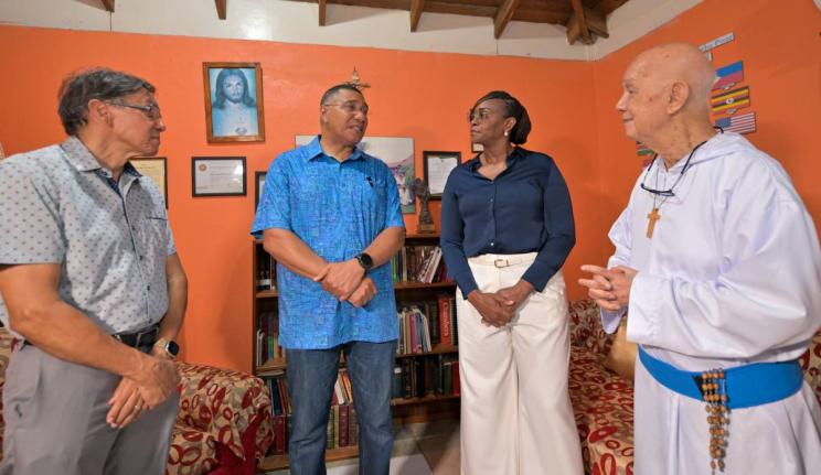 Prime Minister, Dr Andrew Holness (second left), in discussion with Founder of the Missionaries of the Poor, Father Richard Ho Lung (right), during a visit to the Missionaries of the Poor Hanover Street location in downtown Kingston on Wednesday (August 19