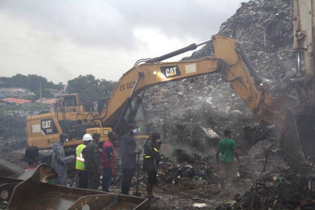 Rescue workers search through a heap of refuse after it collapsed at Conakry’s largest landfill, Guinea, Sunday, Aug. 23, 2026. (AP Photo/Fodo Toure)