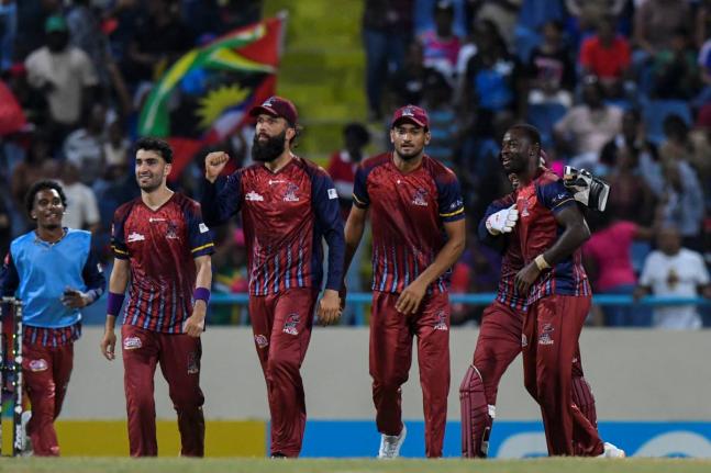 Antigua and Barbuda Falcons captain Moeen Ali (second left) pumps a fist in celebration of beating the Barbados Tridents at the end of a Republic Bank Caribbean Premier League match at the Sir Vivian Richards Stadium on Tuesday.