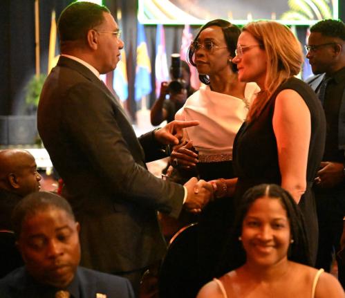 Prime Minister Dr Andrew Holness greets Minister of Health, Environment and Sustainability of the Cayman Islands, Katherine Ebanks-Wilks, during the opening ceremony for the 48th Regional Conference of the Commonwealth Parliamentary Association (CPA), Cari