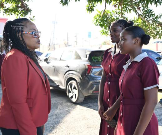 Principal of Herbert Morrison Technical High School, Lavern Stewart, in conversation with grade seven students Tiana Roache and Kiara Donaldson on the first day of school on September 7, 2026