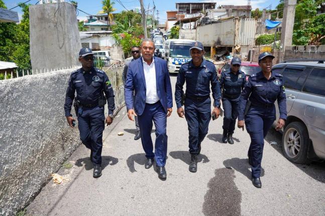 Acting Commissioner of Police Clifford Blake and senior police officers from Area One and St James touring sections of Crawford Street in Mt Salem yesterday.