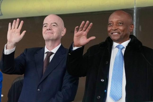 CAF President Patrice Motsepe and FIFA President Gianni Infantino wave from the tribune during the Africa Cup of Nations round-of-16 football match between South Africa and Cameroon in Rabat, Morocco, Sunday, January 4.