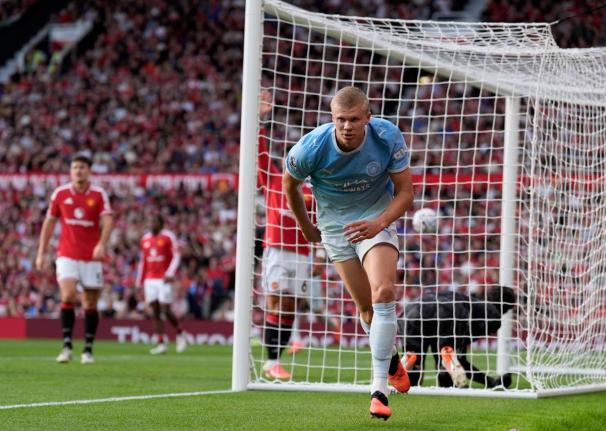 Manchester City's Erling Haaland celebrates after scoring his sides first goal during the English Premier League soccer match against Manchester United in Manchester, England, Sunday. (AP)