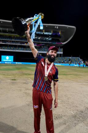 Antigua and Barbuda Captain Moeen Ali raises the Republic Bank Caribbean Premier League trophy after defeating the Jamaica Kingsmen in the fnial on Sunday. 