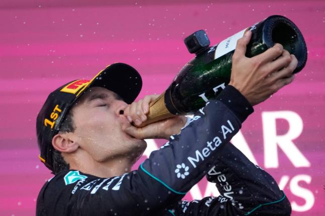 
Mercedes driver George Russell of Britain celebrates after winning the Azerbaijan F1 Grand Prix auto race, in Baku, Azerbaijan, yesterday.