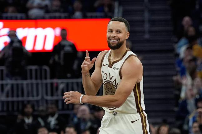 
Golden State Warriors guard Stephen Curry reacts after making a three-point basket during the second half of an NBA basketball game against the Sacramento Kings, Tuesday, April 7, in San Francisco. 