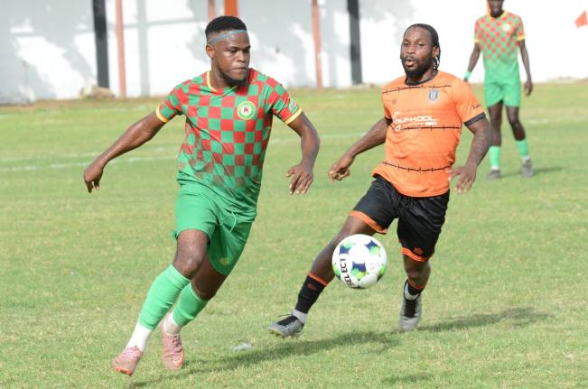 Humble Lion’s Suejay Graham (left) ries to get away from Tivoli Gardens’ Ajuma Johnson during their Jamaica Premier League match at the Edward Seaga Sports Complex  on September 13.