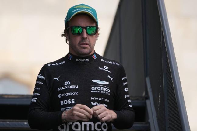 Aston Martin driver Fernando Alonso of Spain walks through the paddock prior to the qualifying session for the Azerbaijan F1 Grand Prix, in Baku, Azerbaijan, on Friday.