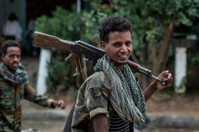 Fighters loyal to the Tigray People’s Liberation Front (TPLF) walk along a street in the town of Hawzen, then controlled by the group, in the Tigray region of northern Ethiopia.