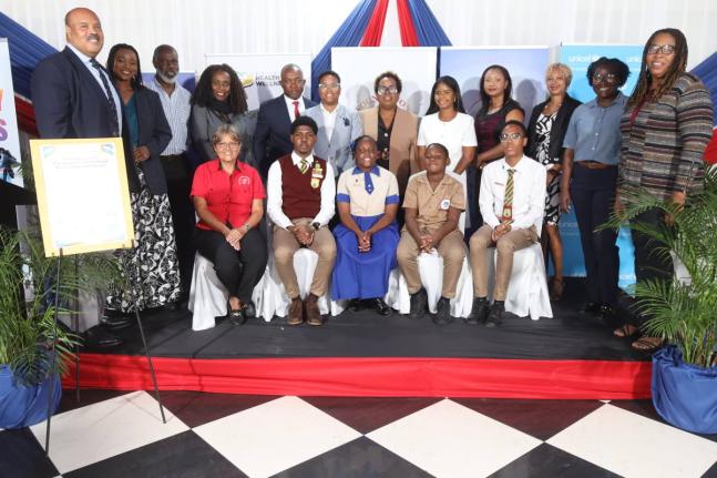 Group photo of the representatives of the signatory organisations and school children at the launch of “Weight a Bit… Turning the Tide on Childhood Obesity in Jamaica” on September 30.