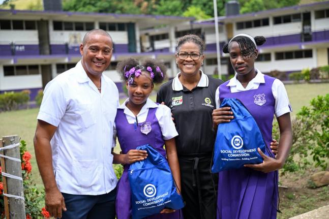 Principal of Robert Lightbourne High School, Ricardo Morgan (left), and St Thomas Social Development Commission Parish Manager, Lorian Peart-Roberts (second right), pose with students Melissa Douglas (second left) and Amelia Drysdale during the staging of 