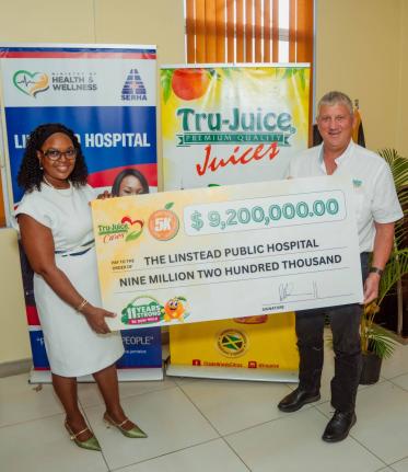 Peter McConnell (right), managing director of Trade Winds Citrus Limited, hands over the Tru-Juice 5K Run/Walk donation to Camile Wallen-Panton, CEO of Linstead Public Hospital, at a ceremony held at the hospital on Monday.