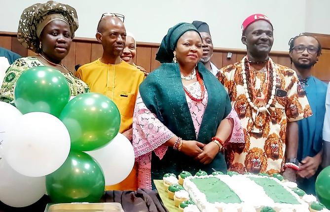 Preparing to cut the cake marking Nigeria's 66th Independence anniversary are (back row, from left) Stephanya Odiase (partially hidden), Adebowale Adeite and Fisayo Otokolo; and (front row, from left) Omolade Iyantan, first secretary at the Nigerian High C