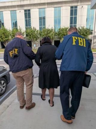 Jamaican national Staciann Pollion Davis being arrested by FBI agents for voting illegally in the United States.