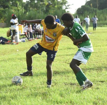 Munro College’s Kajaye Williams (left) shields the ball from Frome Technical High’s Tariq Maxwell during an ISSA Ben Francis Cup knockout match at Frome on September 26.