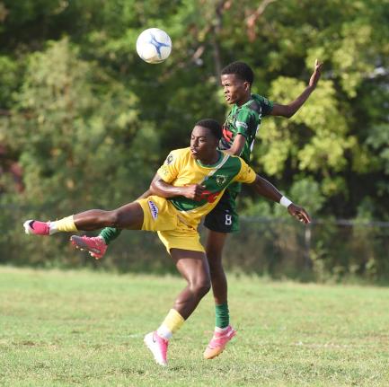 Excelsior’s Damarley Williams (left) and Calabar’s Deshawn Nelson compete for the ball during their Manning Cup football match at Calabar High yesterday. Excelsior won 2-1.