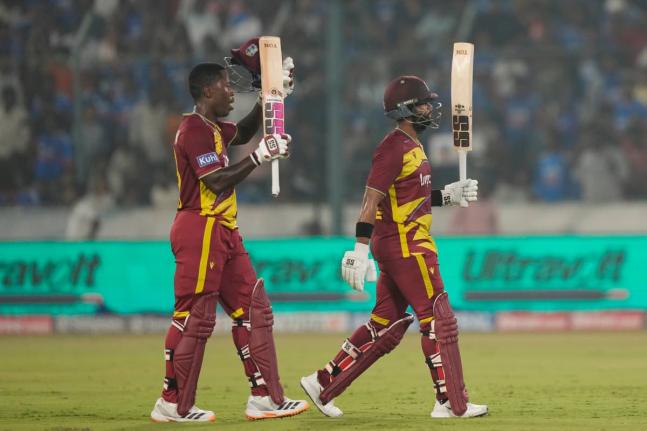 West Indies’ captain Shai Hope (right) celebrates his century as Sherfane Rutherford looks on during the fourth T20 cricket match between India and West Indies in Hyderabad, India, Wednesday, October 14, 2026. 