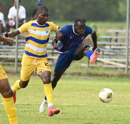 Ricardo Makyn /Chief Photo Editor
Molynes United’s Dhumar McLaughlin (left) tries to stop the challenge of Dunbeholden’s Marlon Allen during a Jamaica Premier League football match at Dunbeholden on October 11.