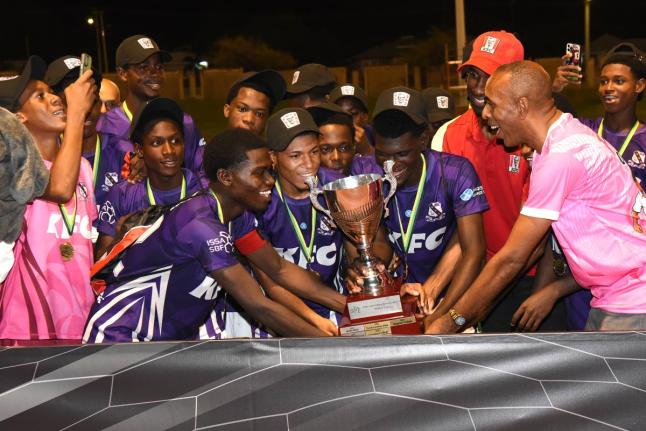 Ian Allen/Photographer 
Keith Wellington (right), President of Inter Secondary Schools Association (ISSA), Andrei Roper (second right) Marketing Manager, Restaurants of Jamaica, present the Walker Cup title to Kingston College captain, Kemaul Patterson sho