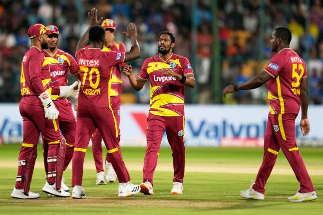 West Indies’ Keemo Paul (second right) celebrates with teammates the dismissal of India’s Abhishek Sharma during the fifth T20 International cricket match against India in Bengaluru, India.