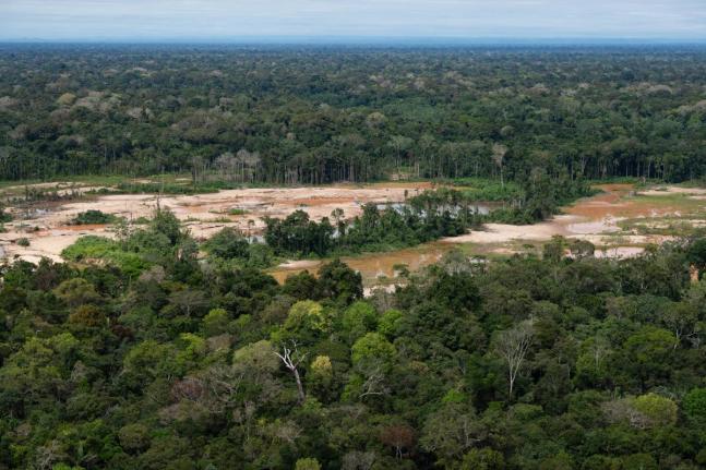 Deforestation from illegal mining surrounds the Malinowski River in the Tambopata National Reserve in Puerto Maldonado, Peru.