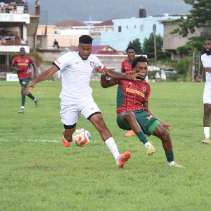 Arnett Gardens’ Earl Simpson (left) and  Richardo Ramsey of Montego Bay United  battle for the ball during their Legend Jamaica Premier League game at Jarrett Park in Montego Bay yesterday.