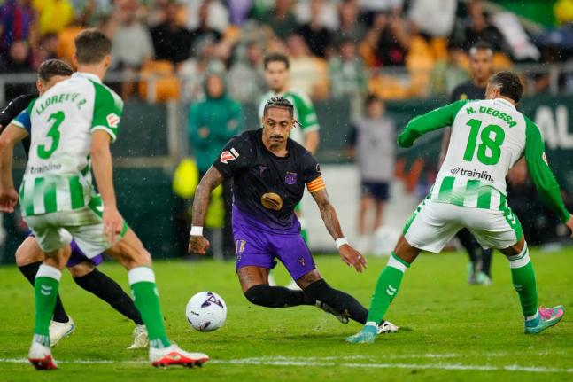 Barcelona's Raphinha (centre) in action during the Spanish La Liga soccer match between Real Betis and Barcelona in Seville, Spain, on Saturday.
