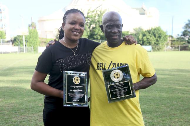 Former national players, Tashana Vinceent and Durrant ‘Tatti’ Brown show off the awards they were honoured with at the Bell/Ziadie Memorial Football Festival at Winchester Park, St George’s College yesterday.