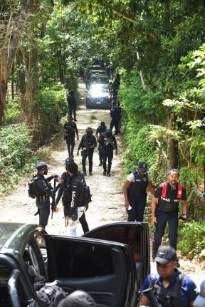 Members of the Jamaica Constabulary Force (JCF) converge on a scene in the Five Miles area of Sligoville in St Catherine where three of their members were shot and three gunmen killed.  One officer died and two are recovering in the hospital.  
