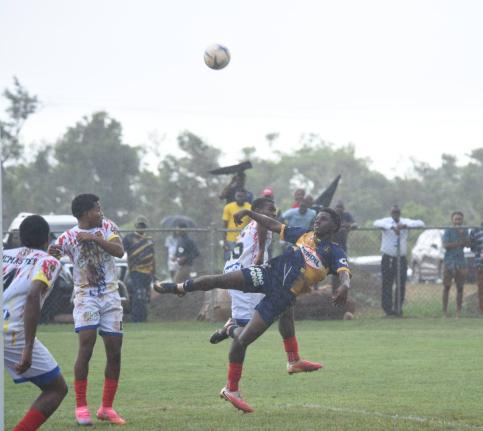 St Elizabeth Technical High School playeers swarm toward Munro College’s Kajaye Williams (right) during their ISSA daCosta Cup second round football game at Munro on October 14. Munro won 2-1.