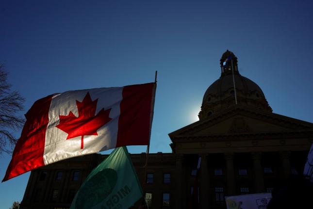 A Canadian flag flies in front of the of the Alberta Legislature during a pro-Canada rally in Edmonton, Alberta, Canada, Sunday.