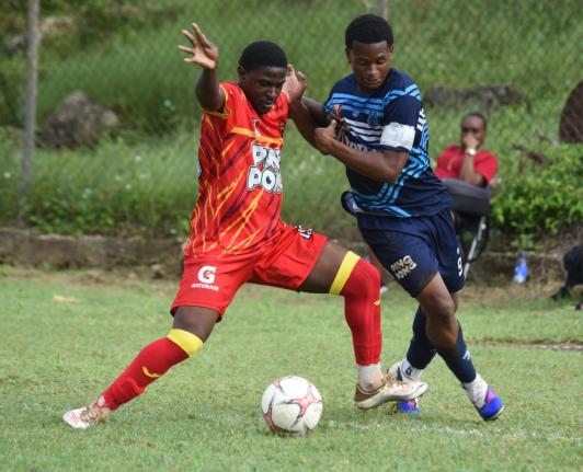 
Cornwall College’s Marcane Gooden (left) and Manning’s School’s captain Jarvis Meylor tussle for the ball during their ISSA daCosta Cup football match at Cornwall yesterday.