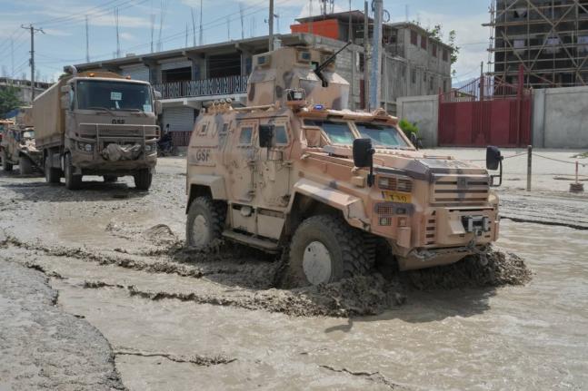 Armored police vehicles that are part of the Gang Suppression Force (GSF) patrol the Tabarre neighborhood of Port-au-Prince, Haiti, on Tuesday.