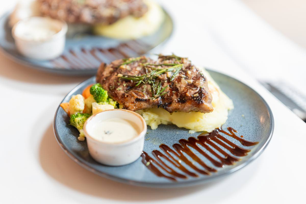 519G’s signature steak served with creamy mashed potatoes and sautéed vegetables.