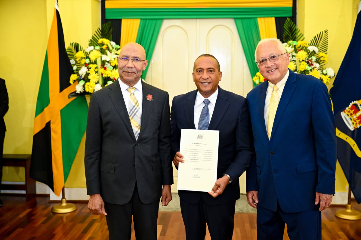 Governor-General, His Excellency Sir Patrick Allen (left), and Minister of Justice and Constitutional Affairs, Delroy Chuck (right), share a photo opportunity with newly appointed Custos Rotulorum for St Elizabeth, Bernard Henry, following his swearing-in 