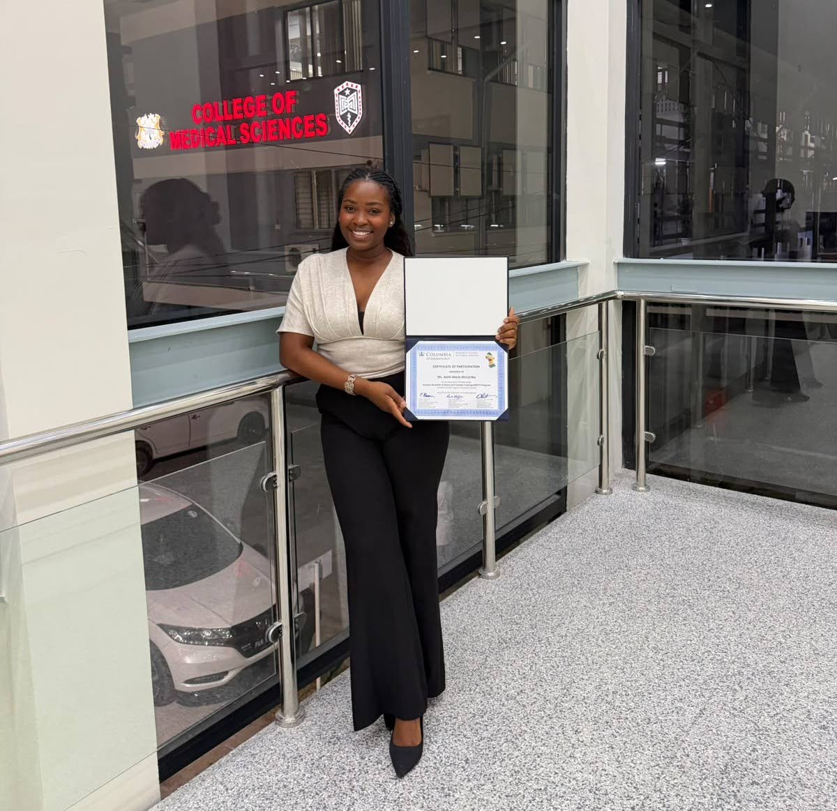 A proud moment for Ashli McCarthy after being awarded a certificate of participation during a joint fellowship between Columbia and Guyana universities. 